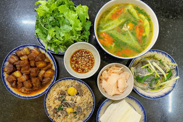 Món ăn ngon trong mâm cơm này có: Canh dọc mùng nấu chua + cá nấu + thịt kho + giá xào lòng gà + đậu phụ + rau sống + măng cay.